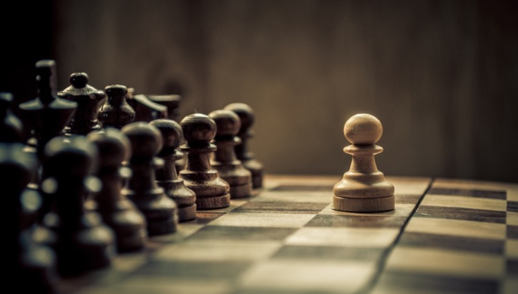 a close up of a chess board with pieces on it.