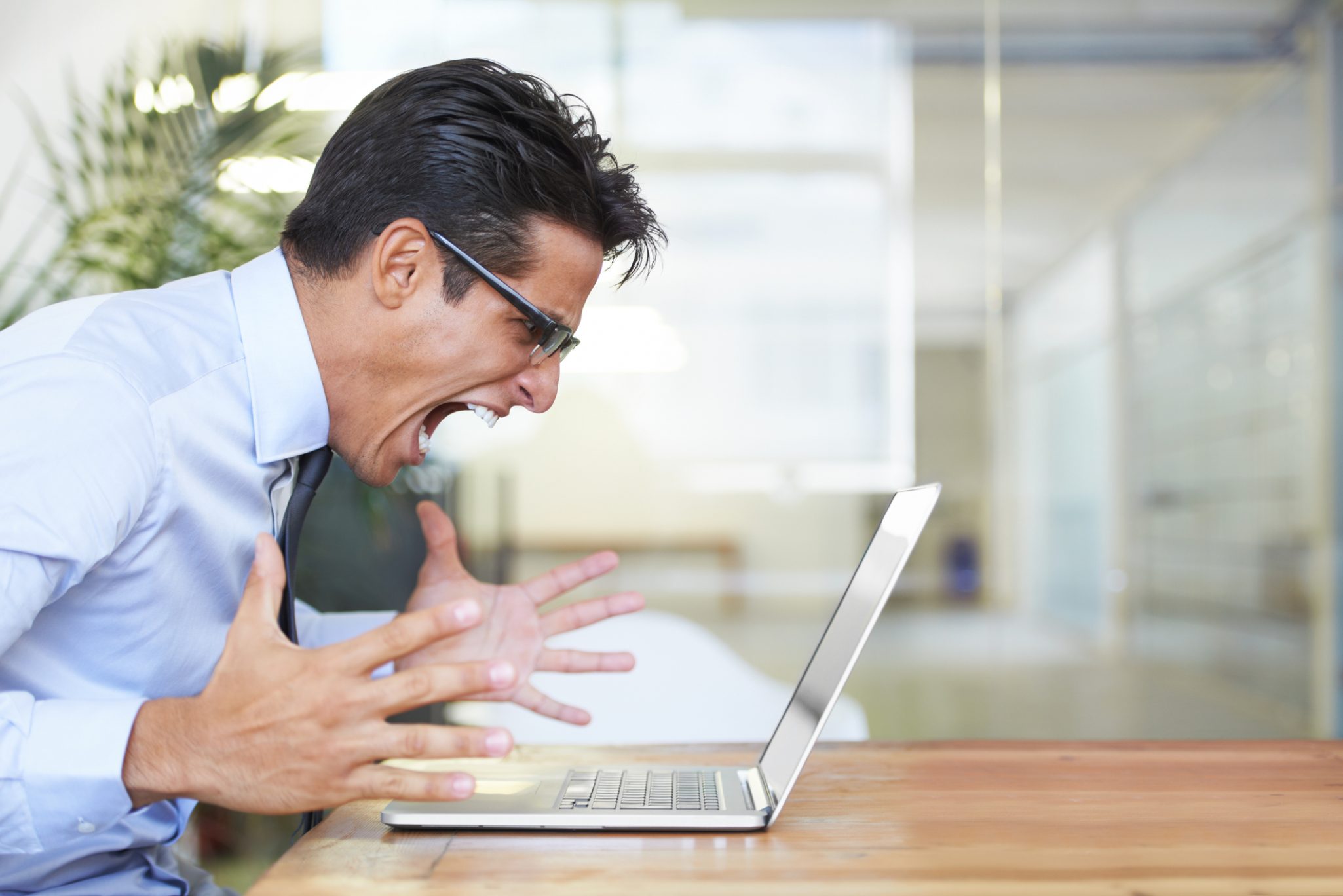 businessman angry at computer struggles to build a positive personal reputation online