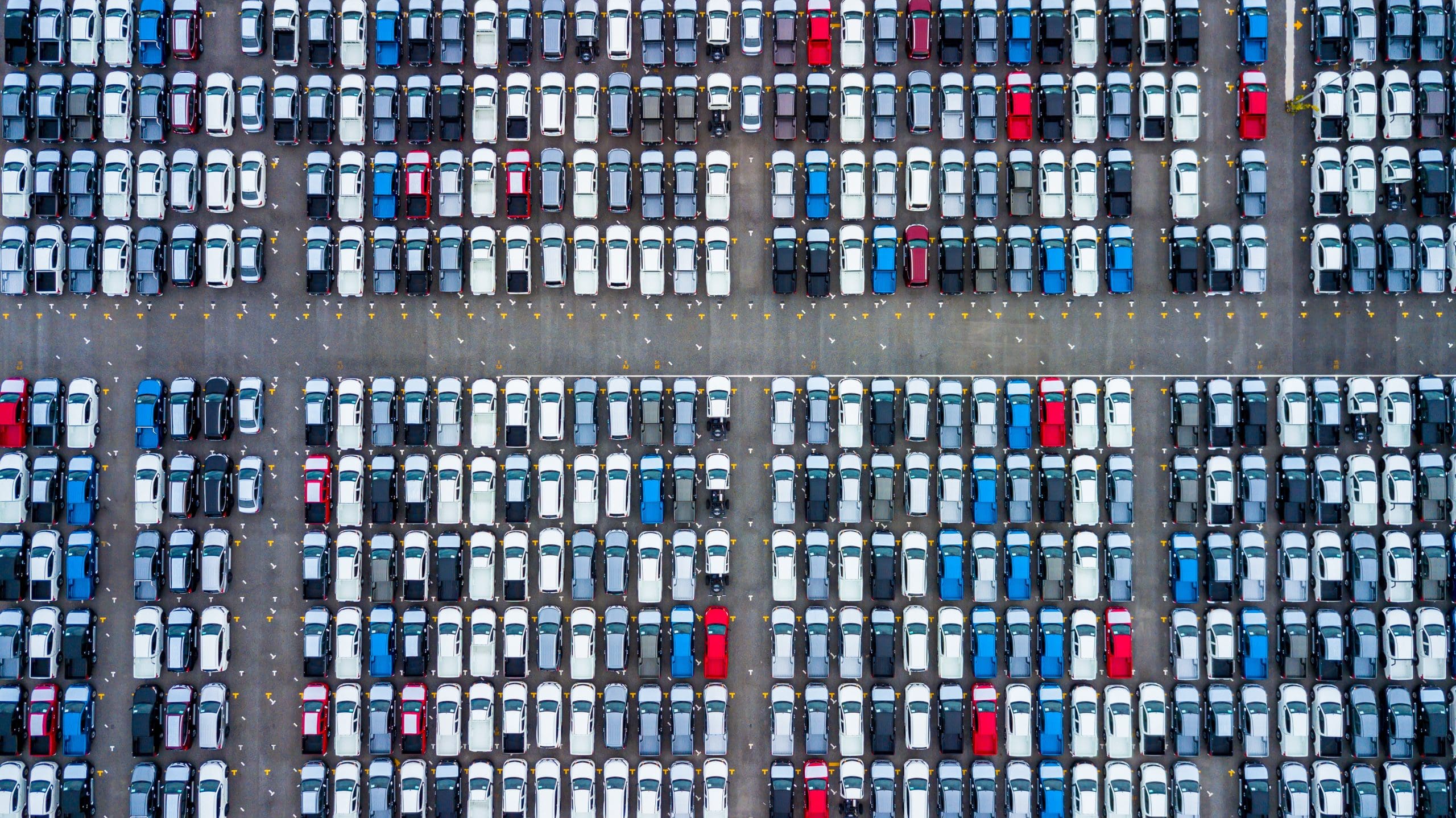 An aerial view of a parking lot full of cars.