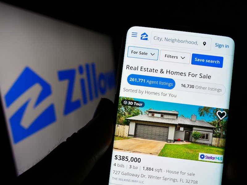 A smartphone displays a Zillow real estate listing for a house priced at $385,000. The Zillow logo is visible, along with home details and agent listings. Users can filter searches or find info like "how do I delete my Zillow account.