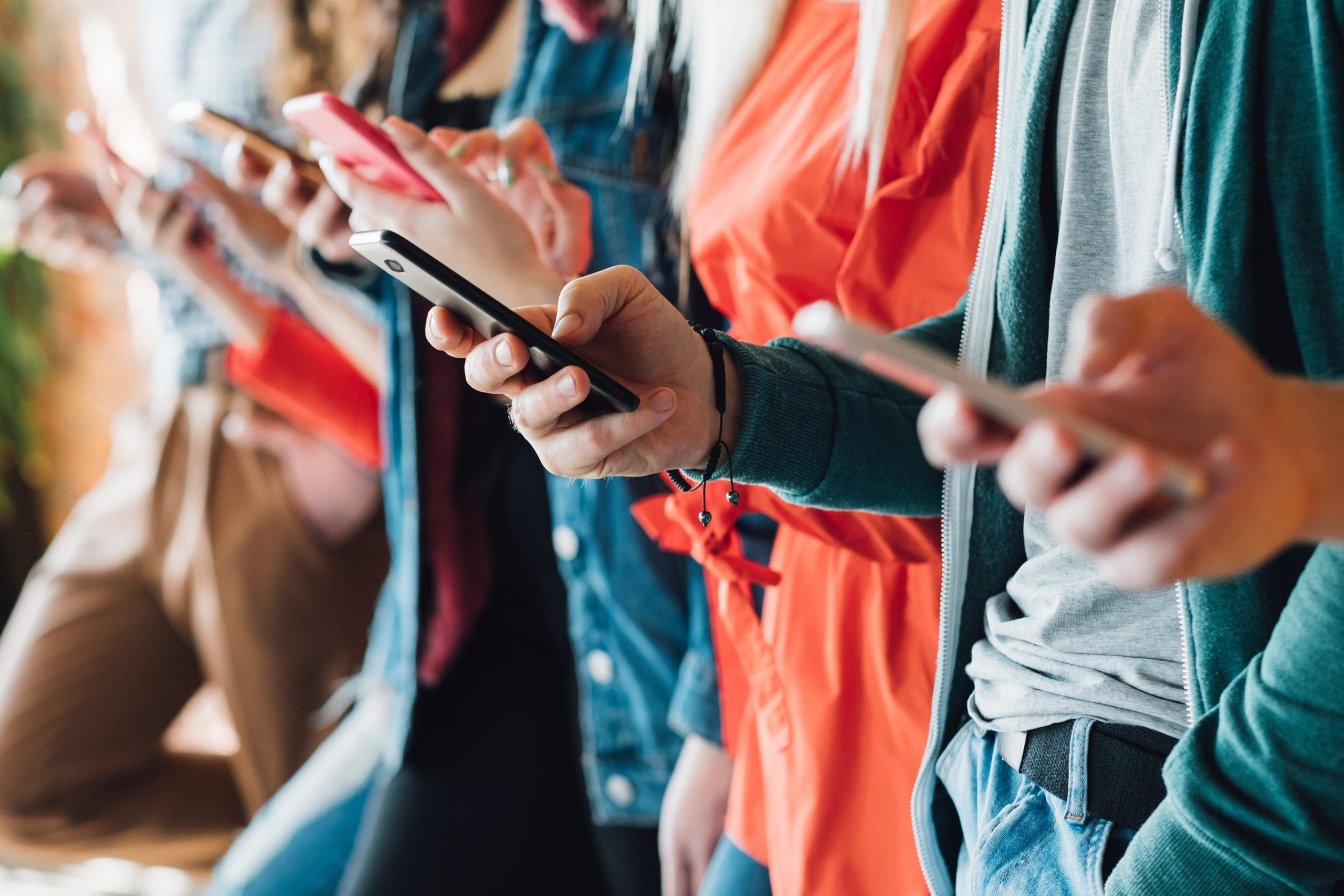 A group of people holding their cell phones.