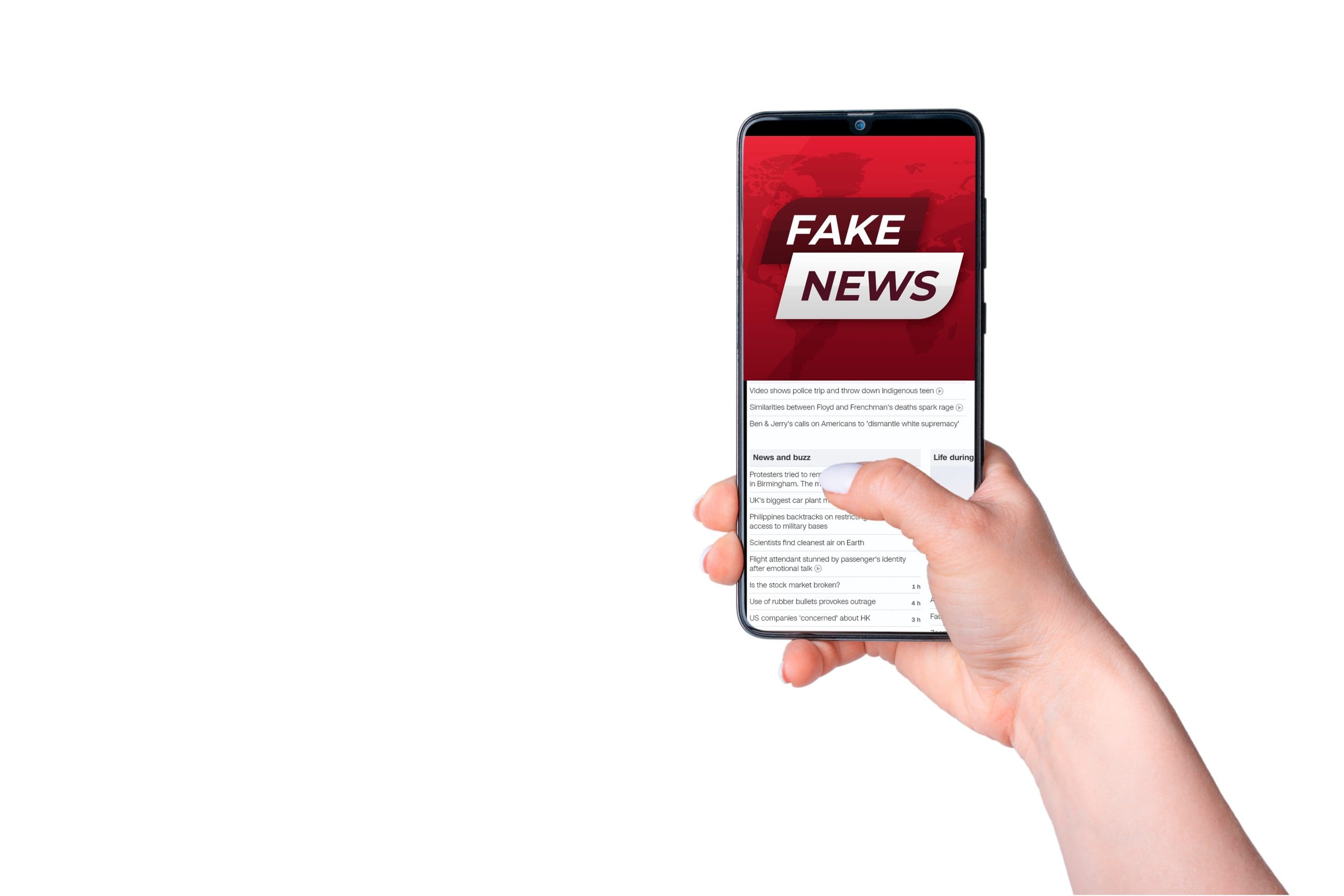 A hand holding a smartphone with the fake news app on it.