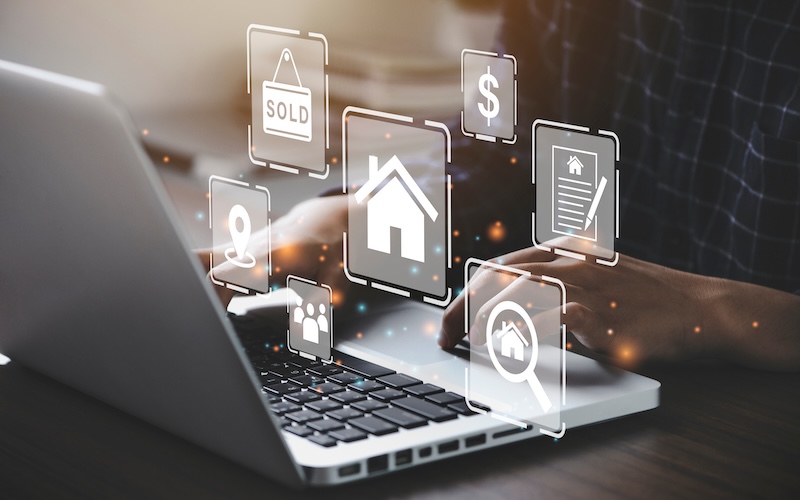 Person typing on a laptop with floating real estate-related icons, including a house, dollar sign, document, and "SOLD" sign—highlighting how realtors need online reputation management for successful digital property transactions.